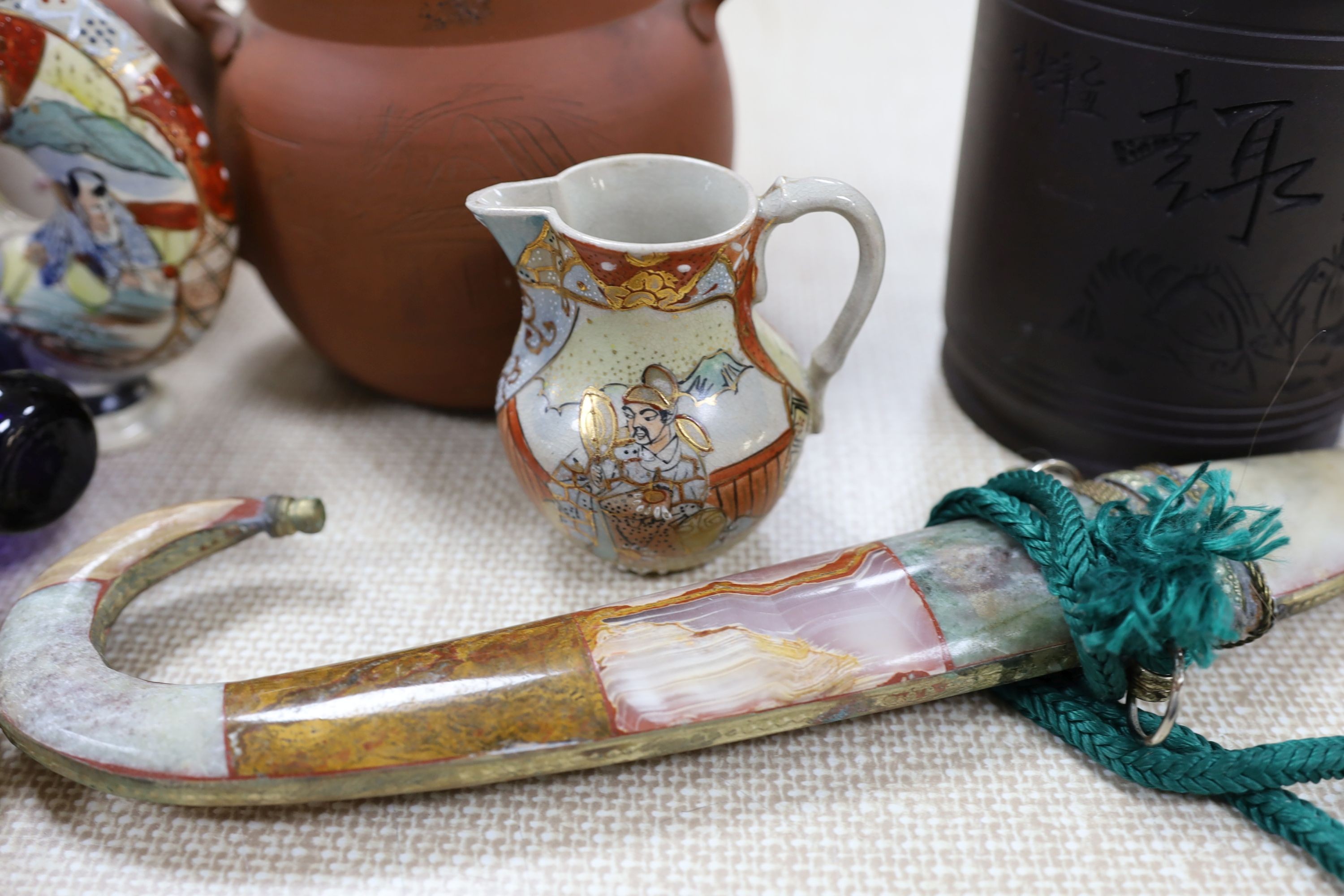 A group of Japanese Satsuma pottery, a Japanese red stoneware teapot, a Chinese Yixing jar and cover, a Middle Eastern dagger and a blue glass rolling pin